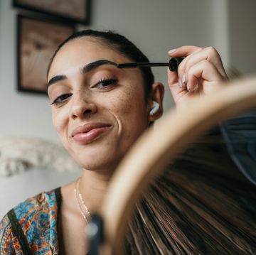 beautiful woman using mascara.