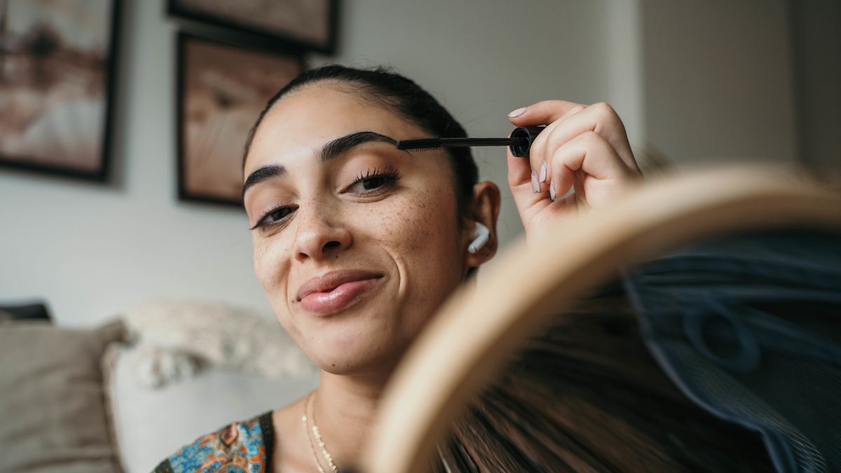 beautiful woman using mascara.