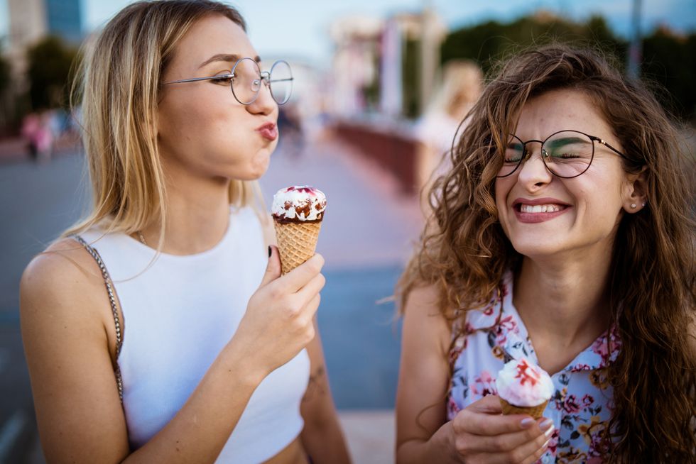 beautiful women eating ice cream in walk