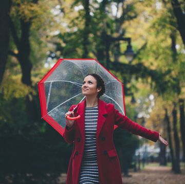 beautiful young woman enjoying a rainy day