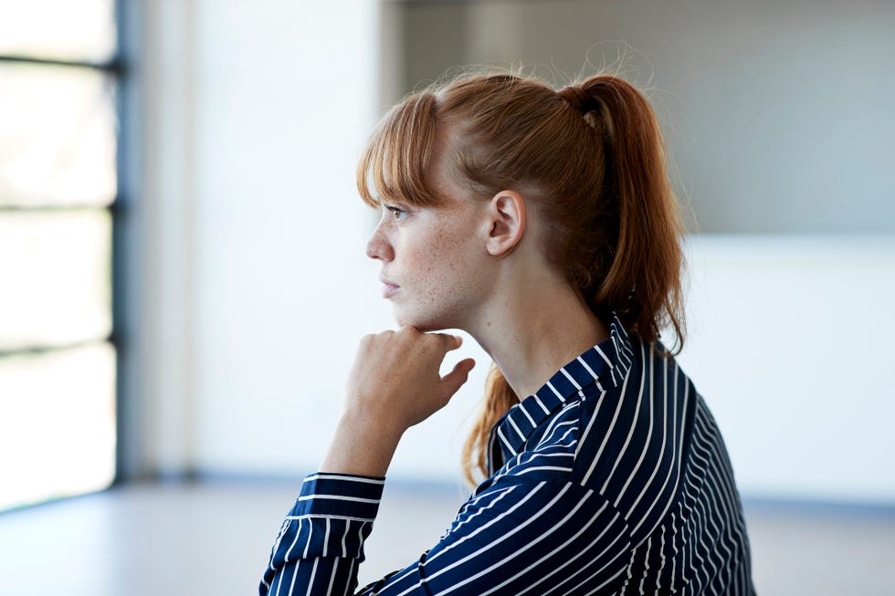 beautiful young woman thinking while looking away