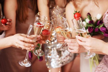 beautiful young women's hands hold glasses of champagne women's party