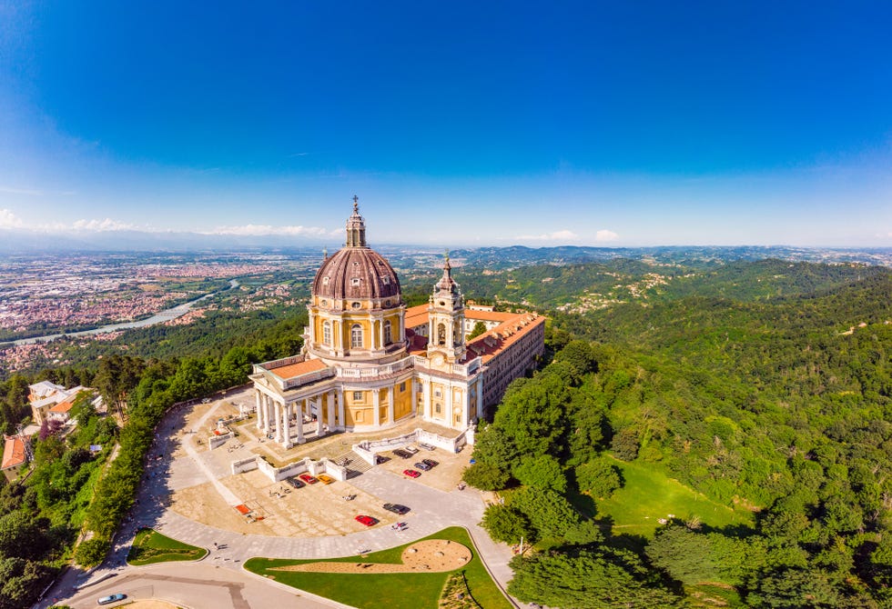 beautifull aerial panoramic view to the famous from the drone basilica of superga in sunny summer day the cathedral church located at the top of hill in italian alps mountains turin, piedmont, italy