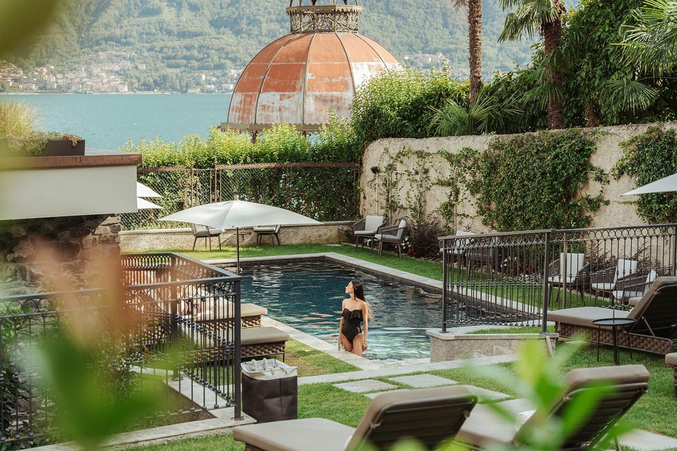 luxury pool area with a view of the lake and mountains