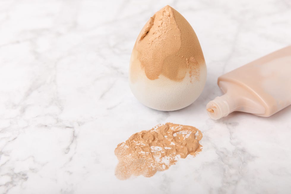 beauty blender and foundation cream on white marble backgroundmakeup cosmetics sponge makeup products beauty concept place for text space for copy flat lay