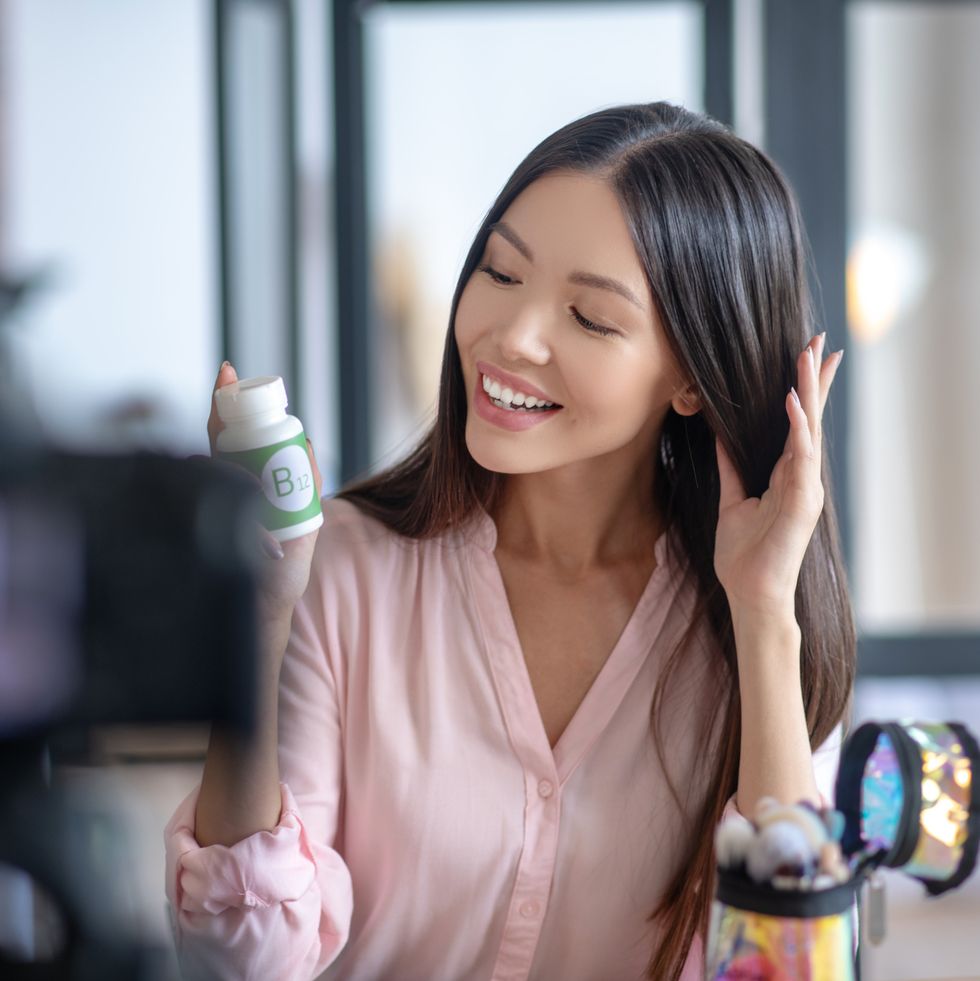 beauty blogger feeling satisfied after taking hair growth vitamins