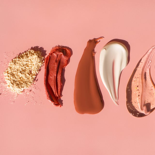 beauty prevention top view of beige face powder and multicolor strokes of various cosmetic products smeared on pink background good for your design