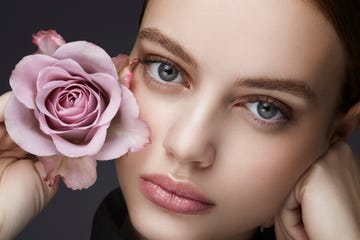 beauty shot of a young woman with a rose in her hand