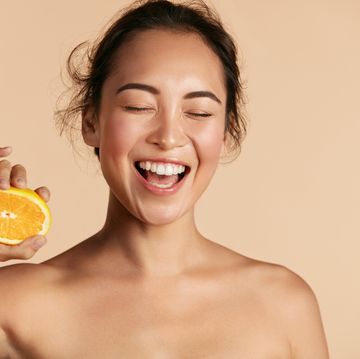 beauty smiling woman with radiant face skin and orange portrait