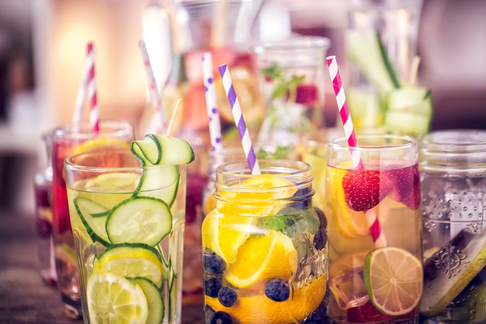 variation of infused water with fresh fruits like raspberries, lemon, pomegranate,berries, oranges, lime and mint