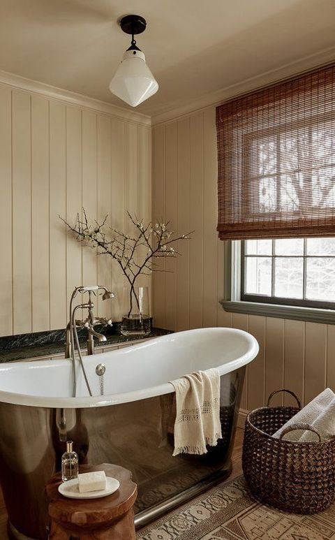 bathroom with silver tub and basket of towels nearby