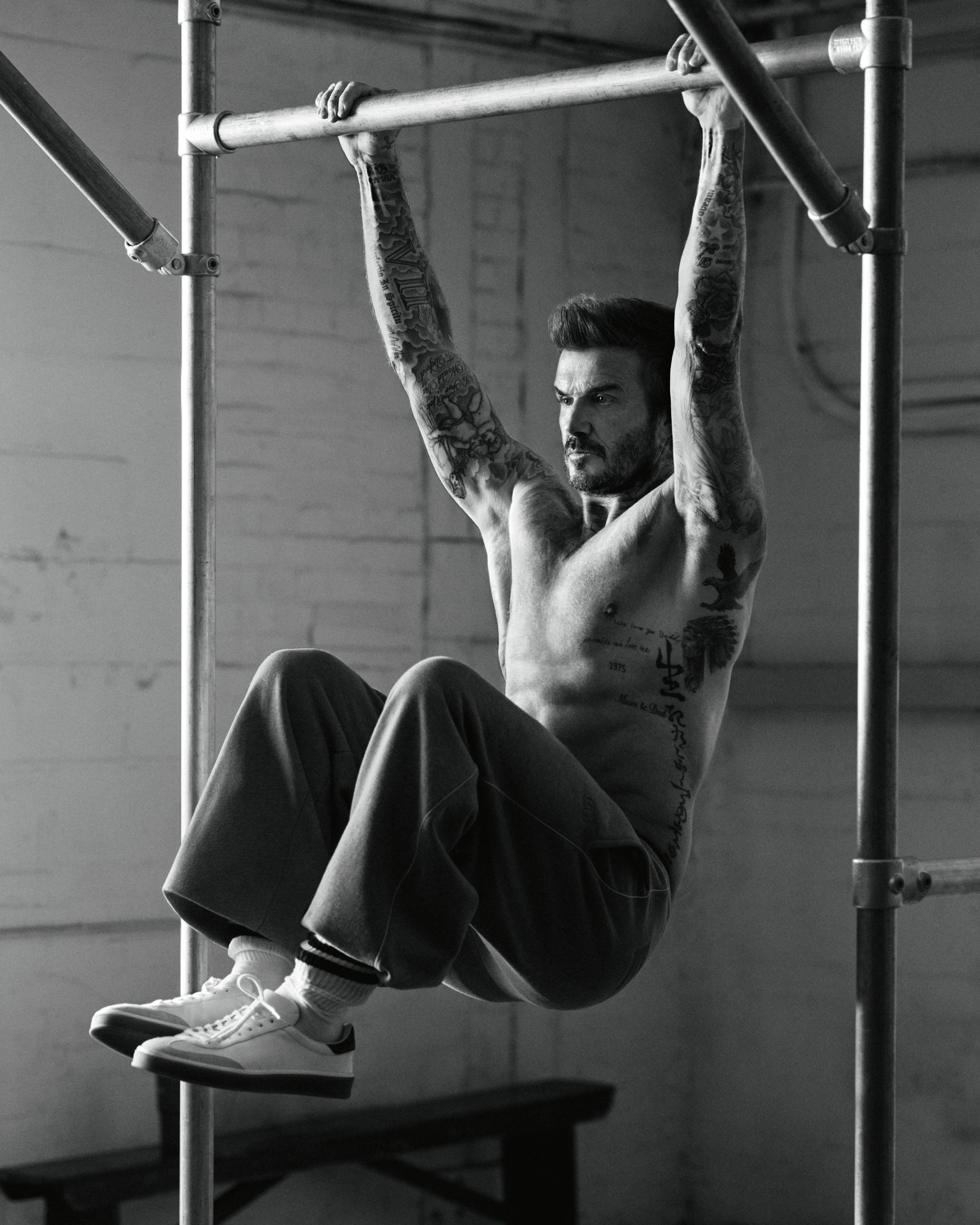 david beckham performing a pullup exercise in a gym setting