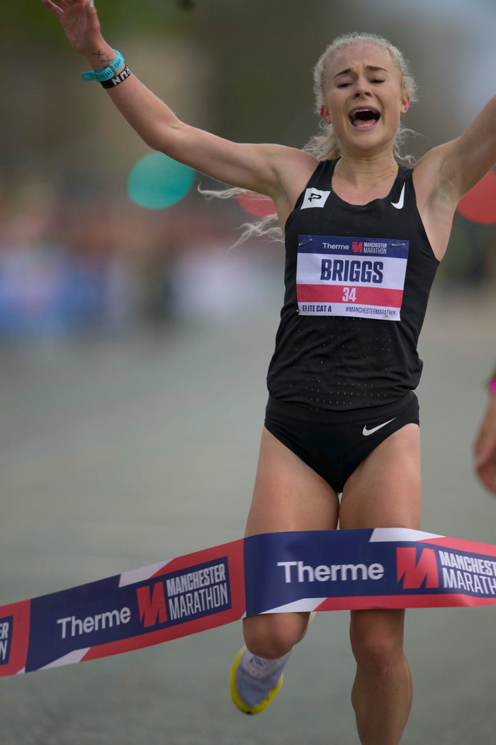 manchester marathon 2022 women's race winner becky briggs crosses the finish line