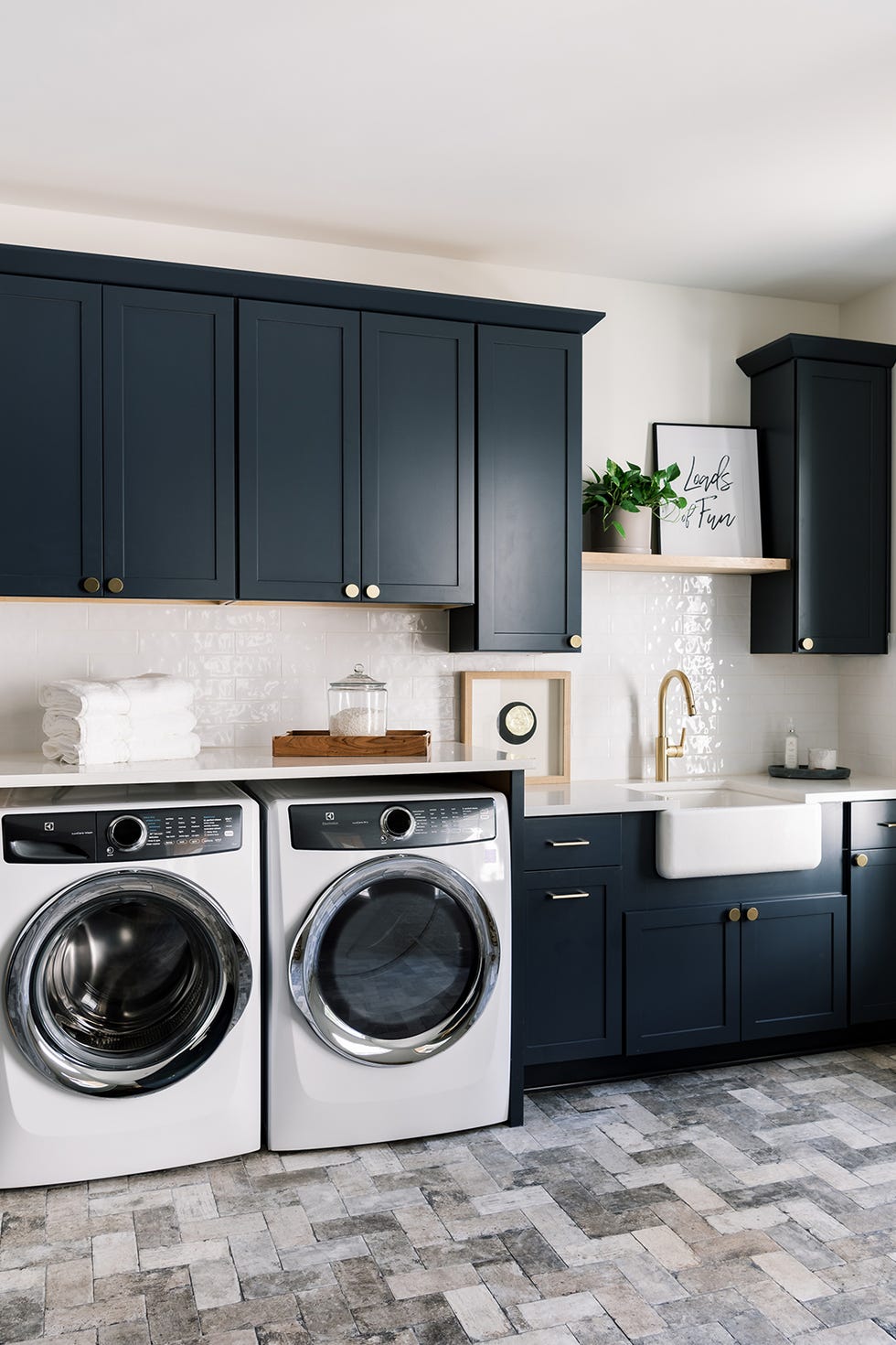 laundry room with dark blue cabinets with white washerdryer