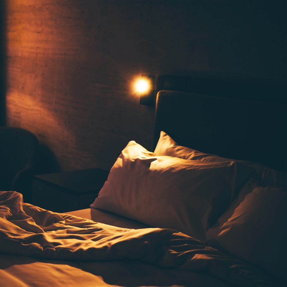 close up of unmade bed at night