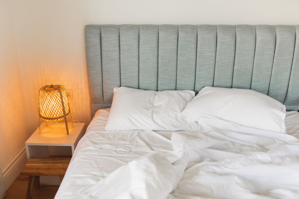 bed in hotel room with crumpled blanket. awakening concept. travel and vacations