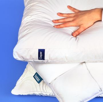 best tested hand pressing down on bed pillows