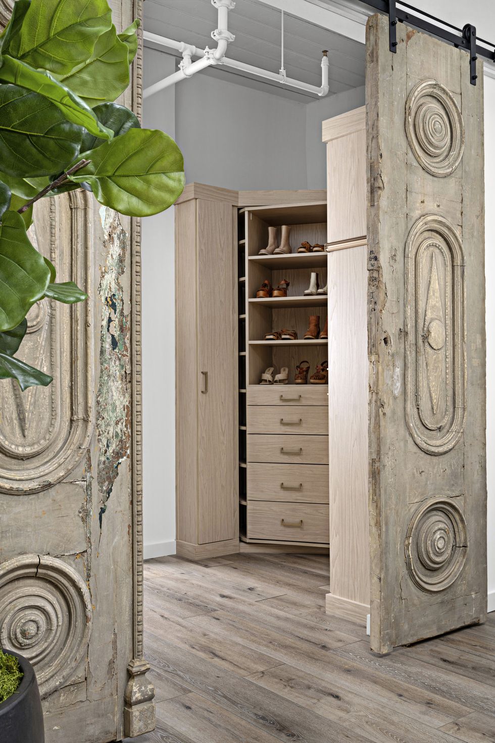 wardrobe
a 360 degree rotating closet system
by closet works features a hidden
full length mirror and ample storage
for shoes sourced from the corbel,
the french doors that close off
the space are from the 1800s