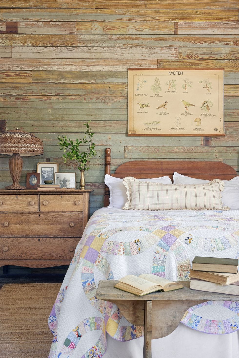 homeowners built the wall behind the headboard using wood salvaged from other parts of the house and there is a quilt on the bed