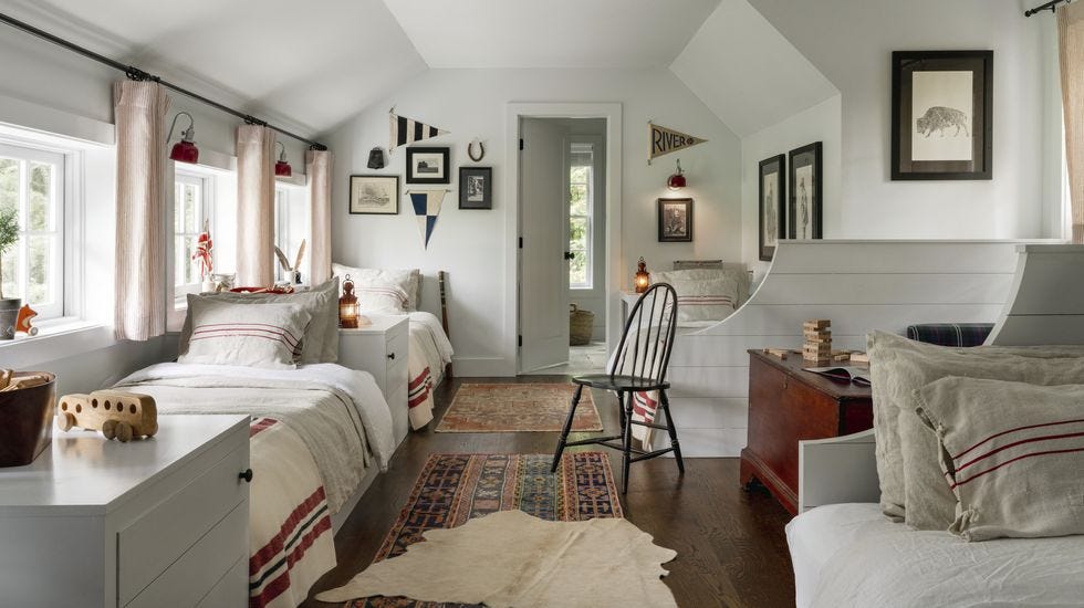 a long bunk room with several beds lining the walls