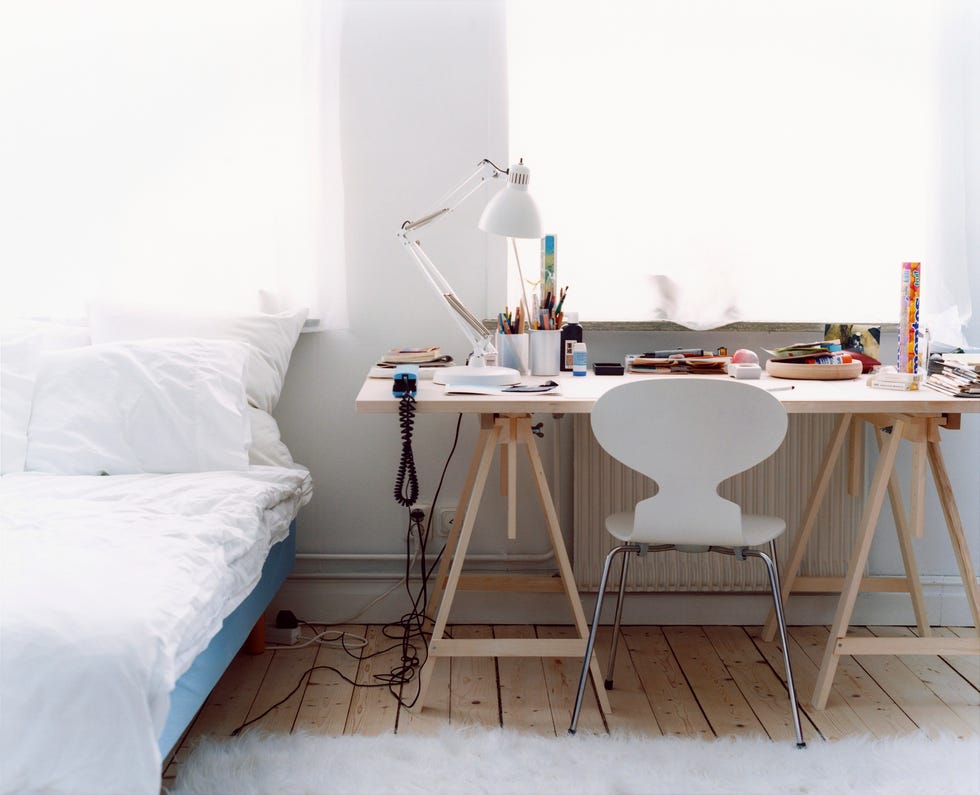 a desk with a chair in a bedroom