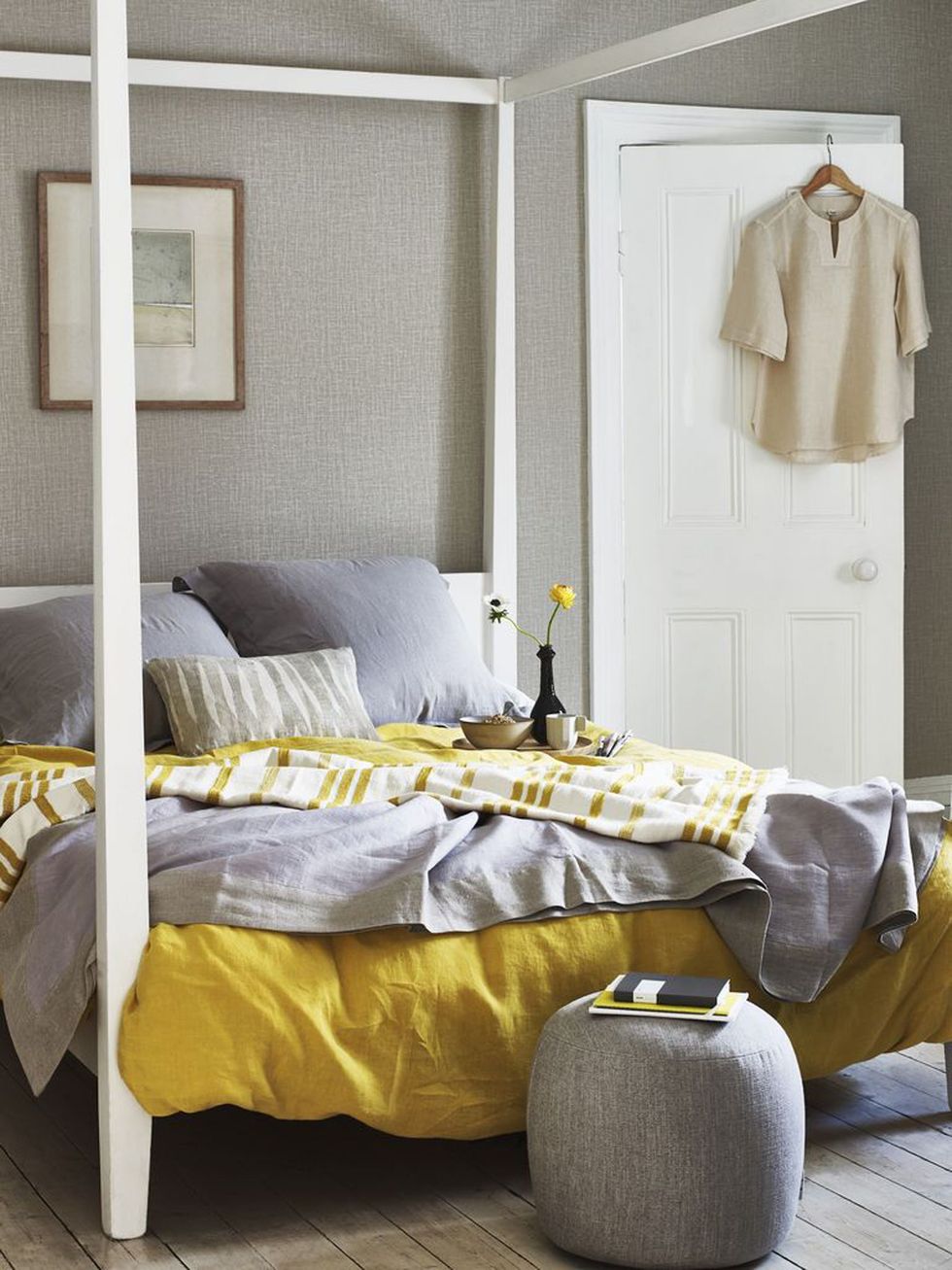 feng shui bedroom, bedroom with white modern four poster bed, grey and mustard yellow bed linen