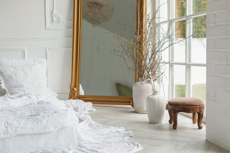 a white bed with a white blanket
