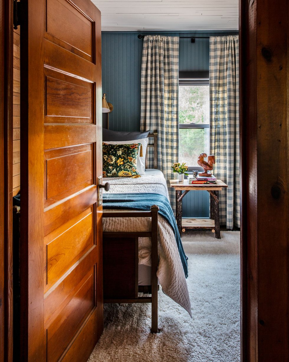 1910 bungalow overlooking valentine lake in michigan designed by erica harrison and the bedroom has gray blue walls