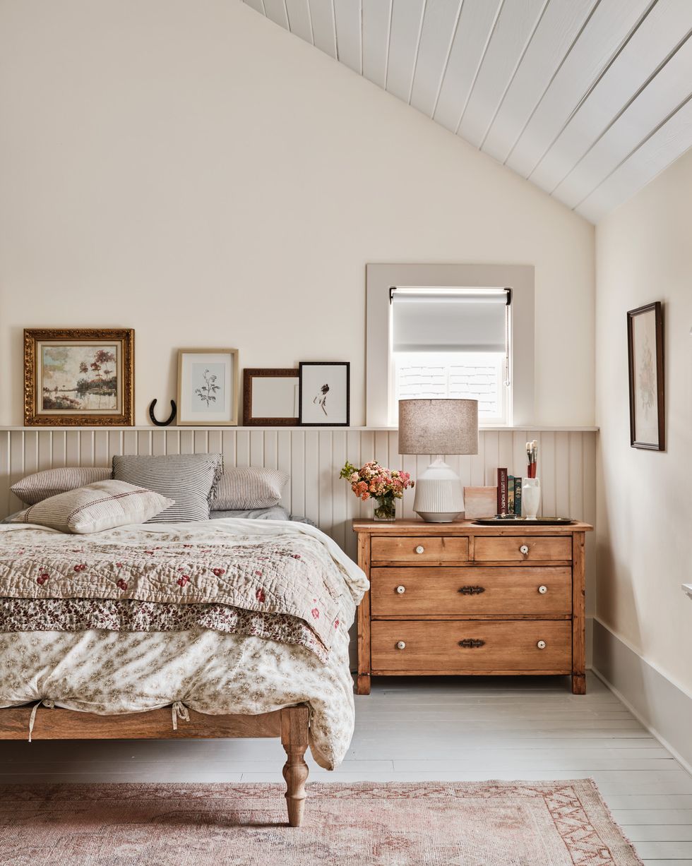 a texas farmhouse bedroom with v groove paneling and neutral colors