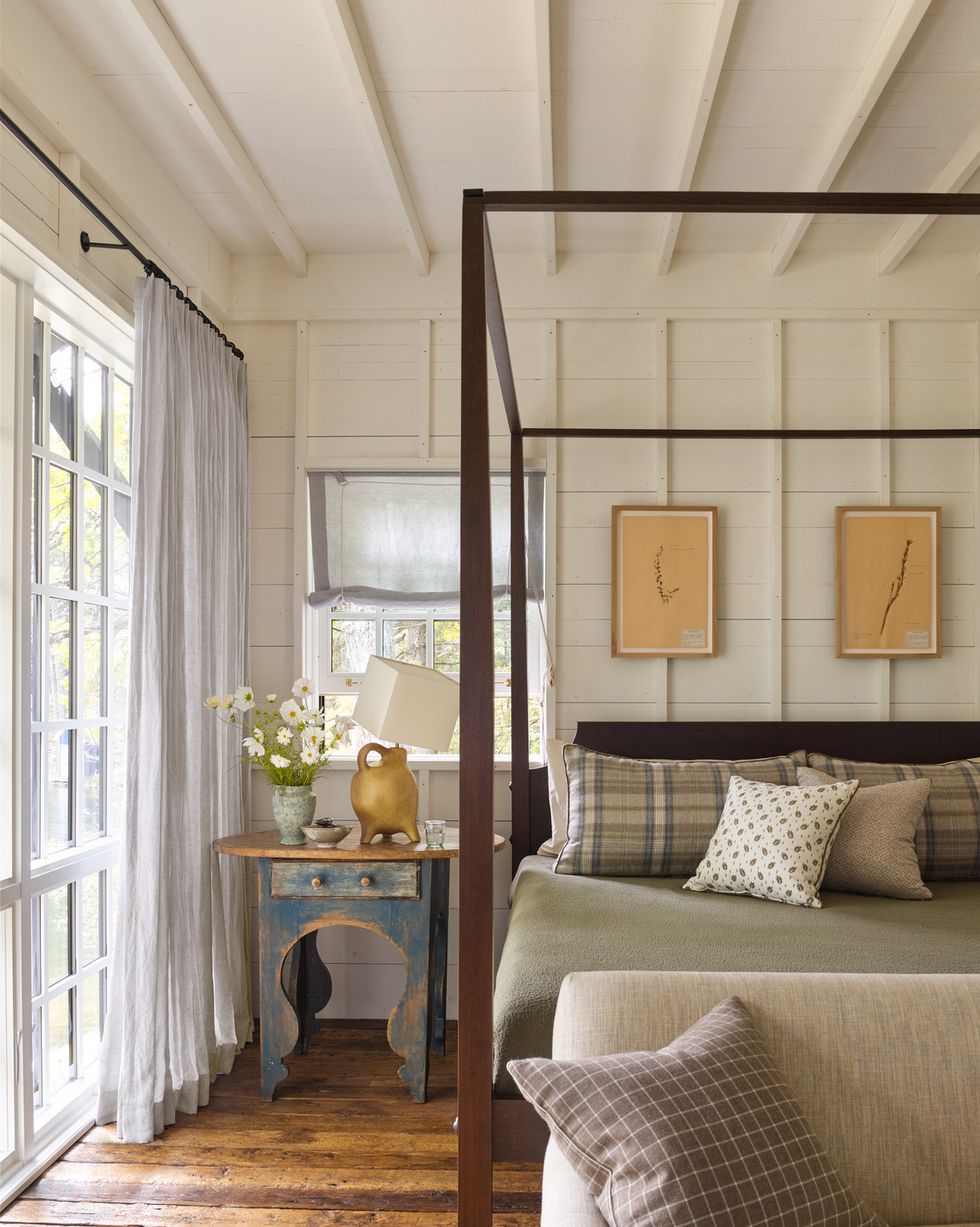 a bedroom in michigan lake house with cream colored board and batten walls
