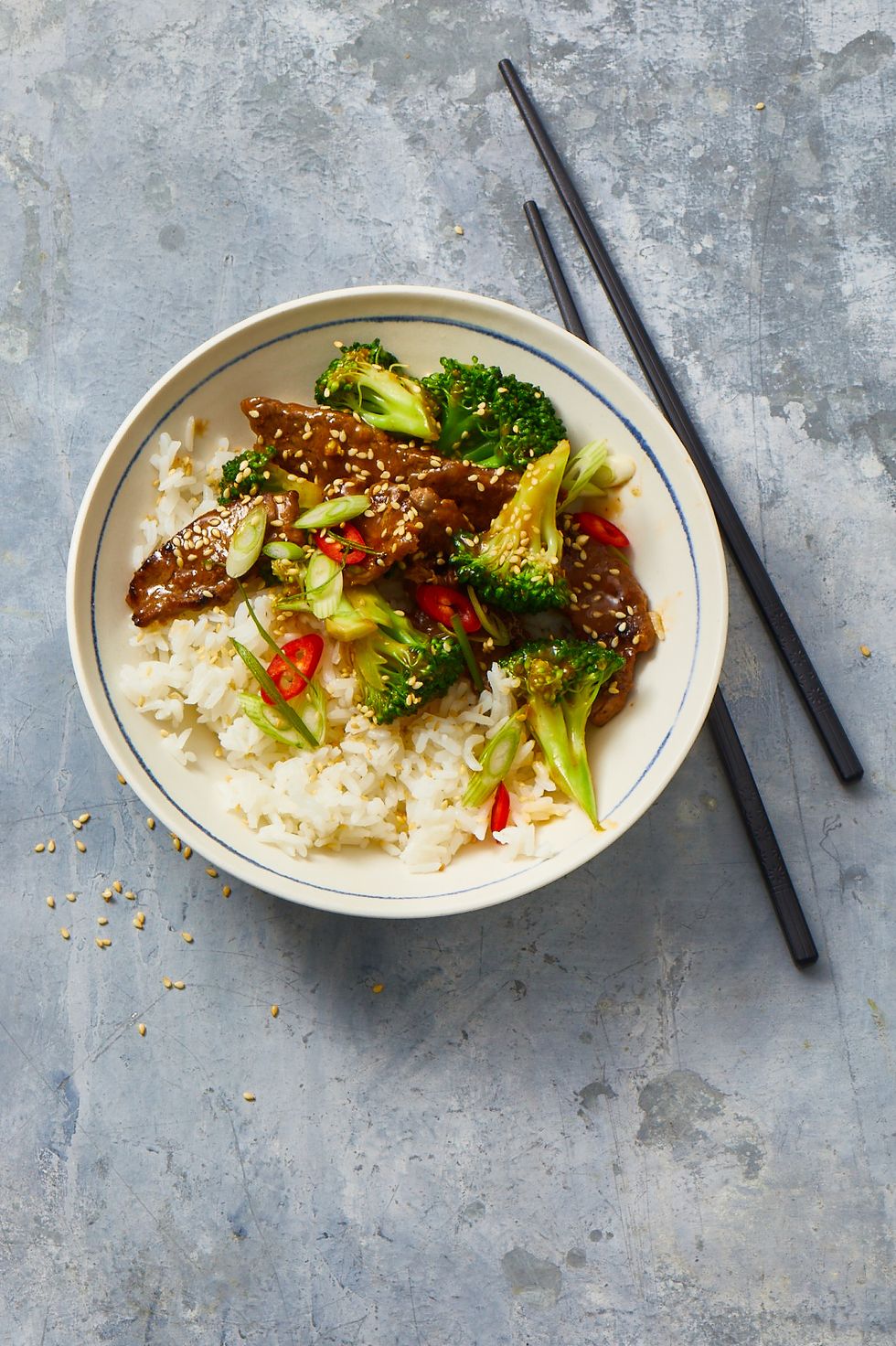 beef and broccoli with white rice in a bowl