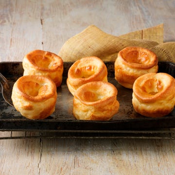Beef dripping Yorkshire puddings on metal baking tray and wire rack Beef dripping Yorkshire puddings on metal baking tray and wire rack