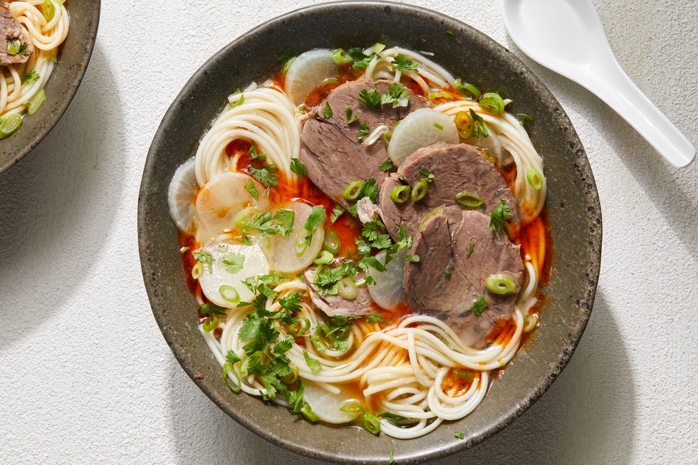 beef noodle soup with beef shank, chili oil, daikon, and scallions