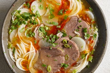 beef noodle soup with beef shank, chili oil, daikon, and scallions