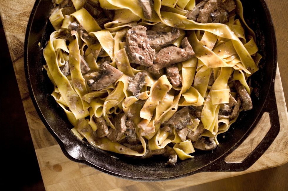 beef stroganoff in a bowl on a wooden counter