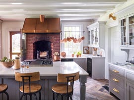 white and gray farmhouse kitchen with brick hearth