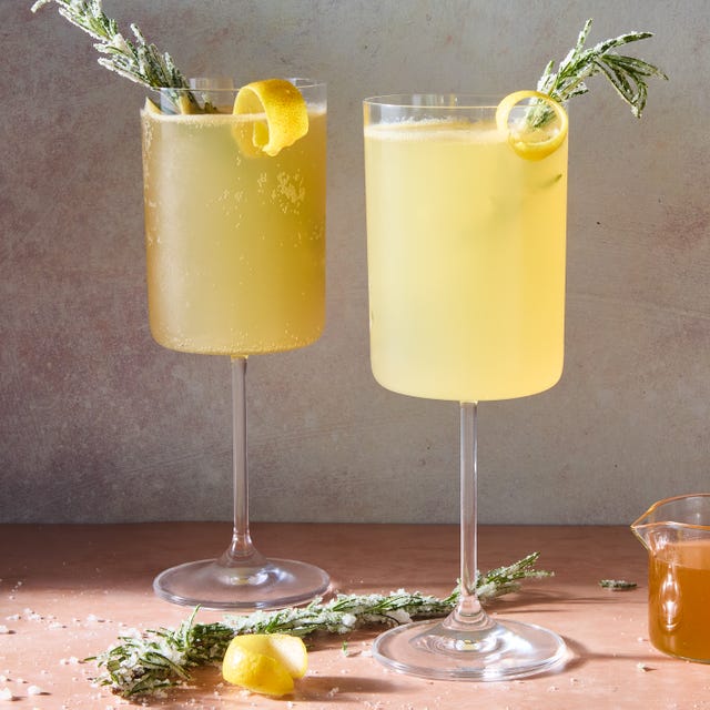 bee's knees mocktail spritz with a lemon twist and sugared rosemary