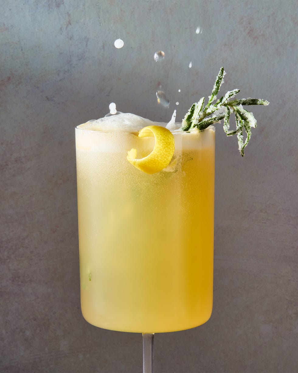bee's knees mocktail spritz with a lemon twist and sugared rosemary
