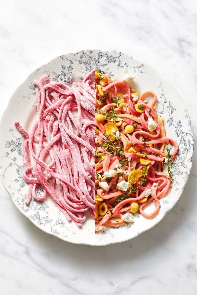 beet fettuccine with hazelnuts and goat cheese on a white plate with floral designs