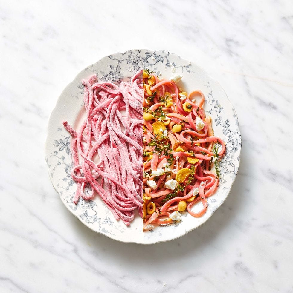 beet fettuccine with hazelnuts and goat cheese on a white plate with floral designs