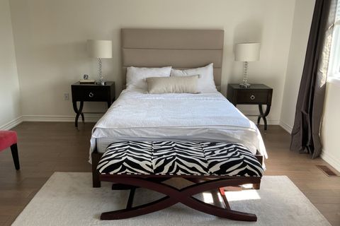 bedroom before with zebra bench and black night stands
