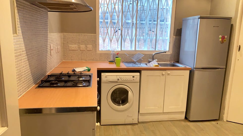 Small old-fashioned kitchen with washing machine and small lighting