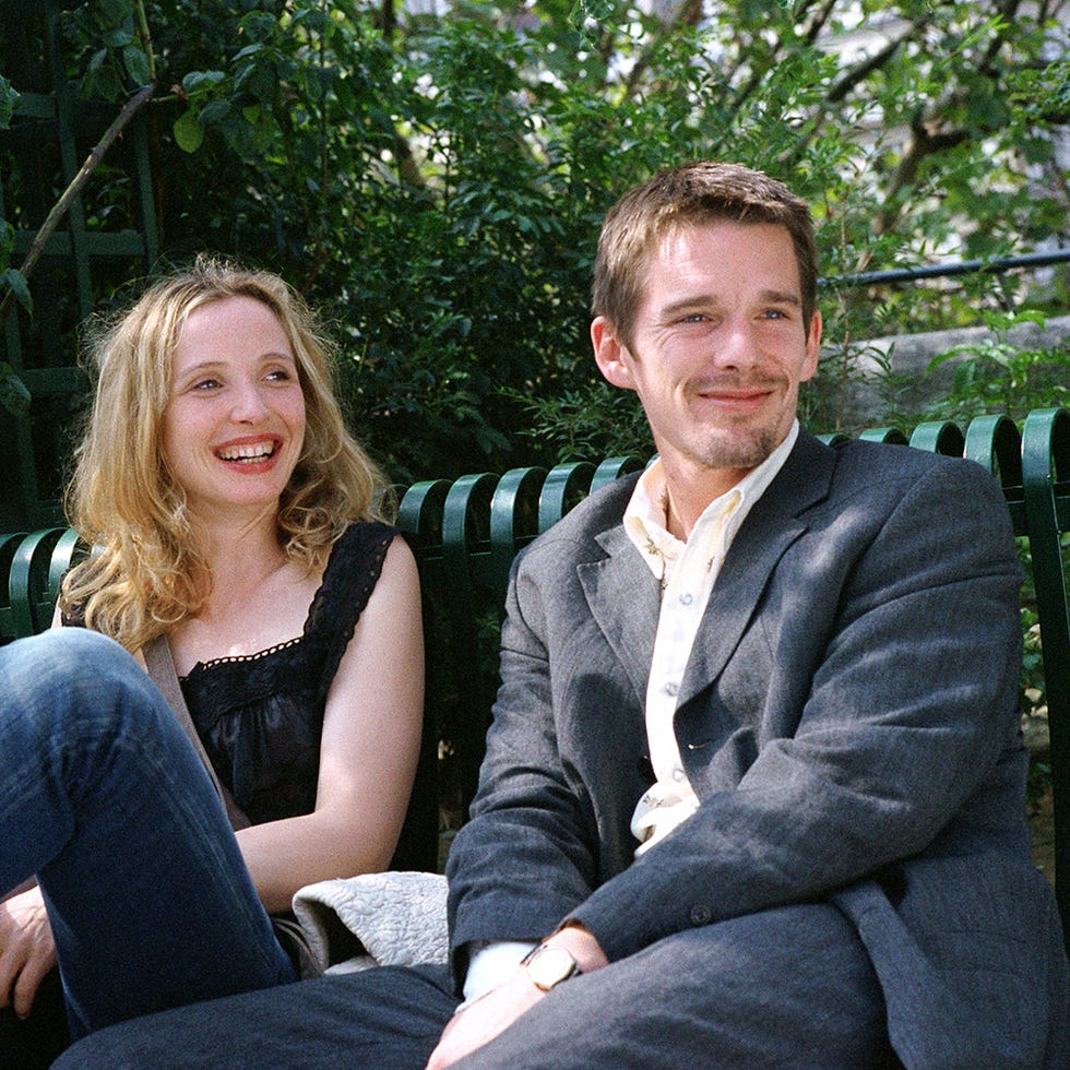 two people are seated on a bench, surrounded by greenery two people are seated on a bench, surrounded by greenery