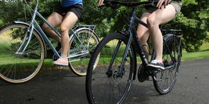 two cyclists learning how to ride bikes with flat pedals