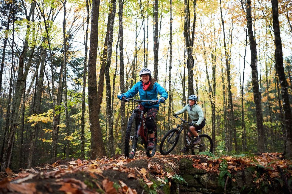 two women riding mountain bike trail