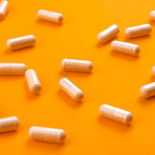 beige pills on a bright orange background