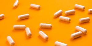 beige pills on a bright orange background