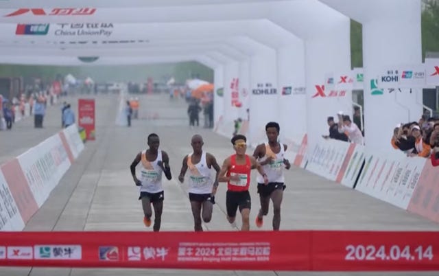 a group of people running on a track