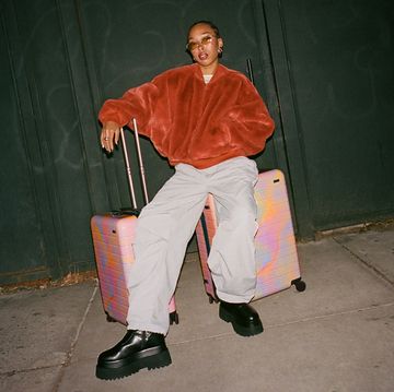 a man sitting on a suitcase
