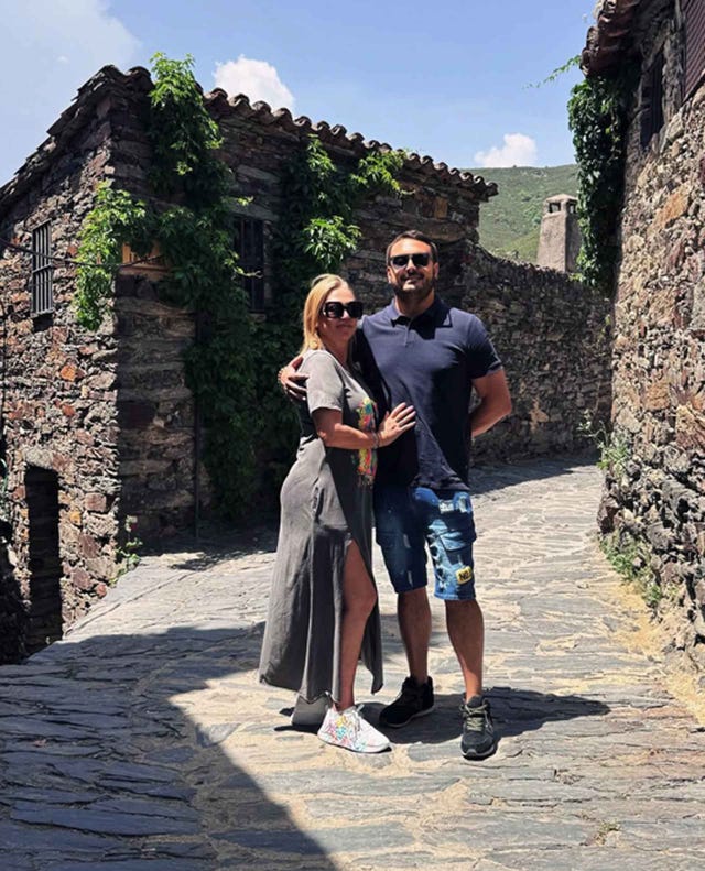 couple posing together in a scenic cobblestone alley